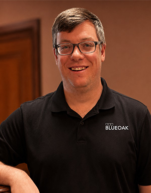 Man in glasses wearing a BlueOak polo shirt