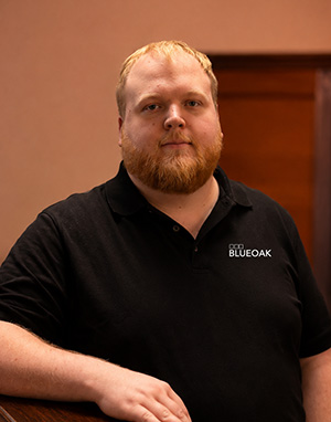 Man with red beard wearing Blue Oak polo shirt